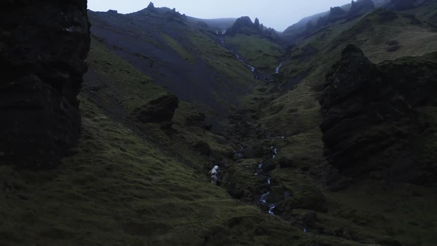 A person hikes down a mountain