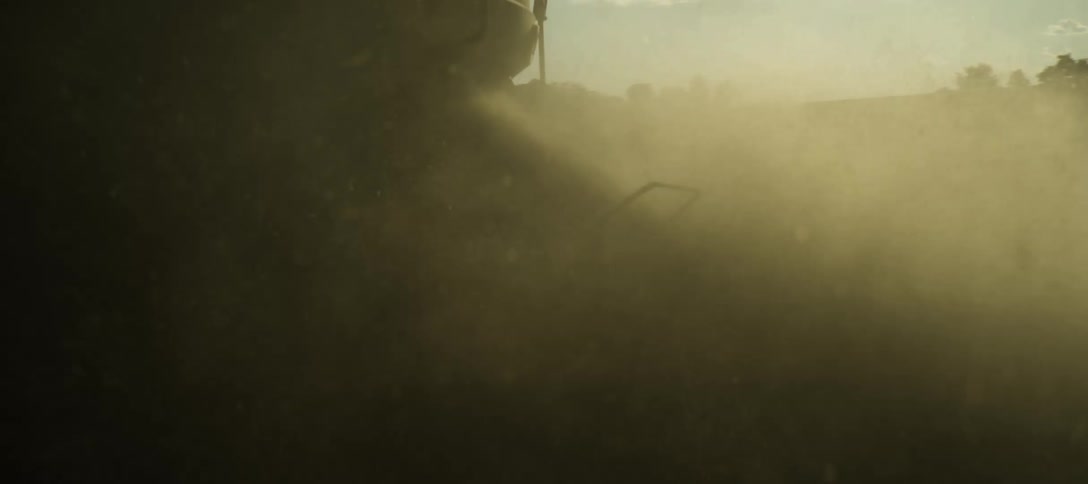 Agricultural machinery in a field in the process of harvesting