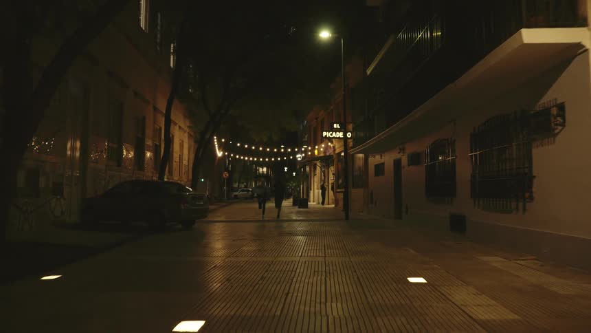 Two people run through a street