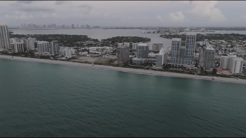 Aerial of a resort destination on an ocean shore at dusk