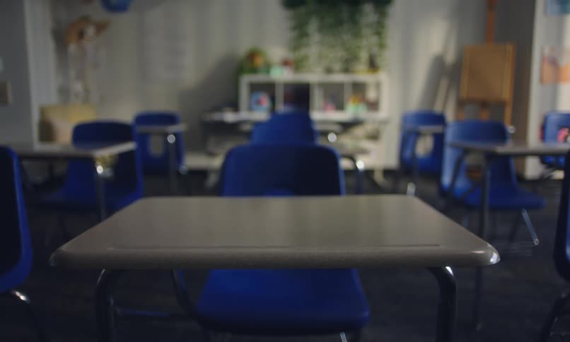 Empty classroom with blue tables and chairs