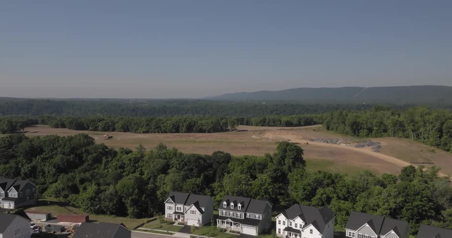 An aerial view of a suburban housing development with twostory houses arranged in a culdesac pattern
