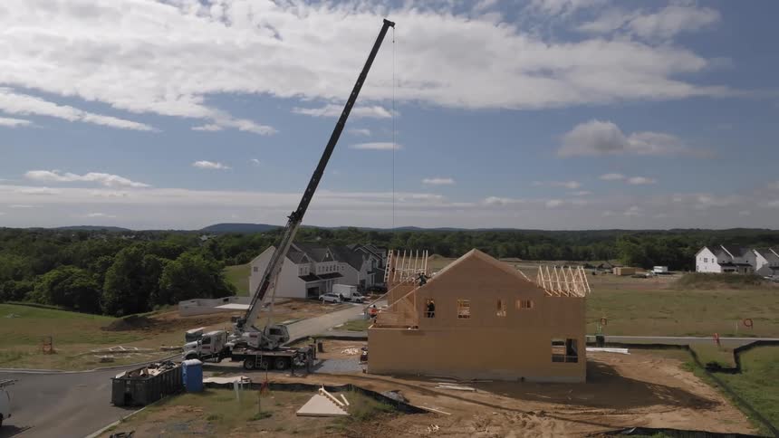 Construction workers building a house in a new neighborhood