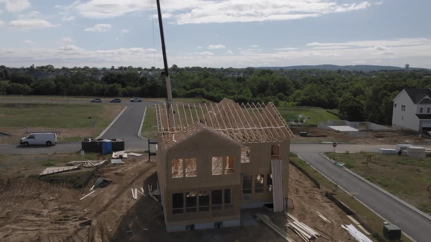 A crane working on a house under construction