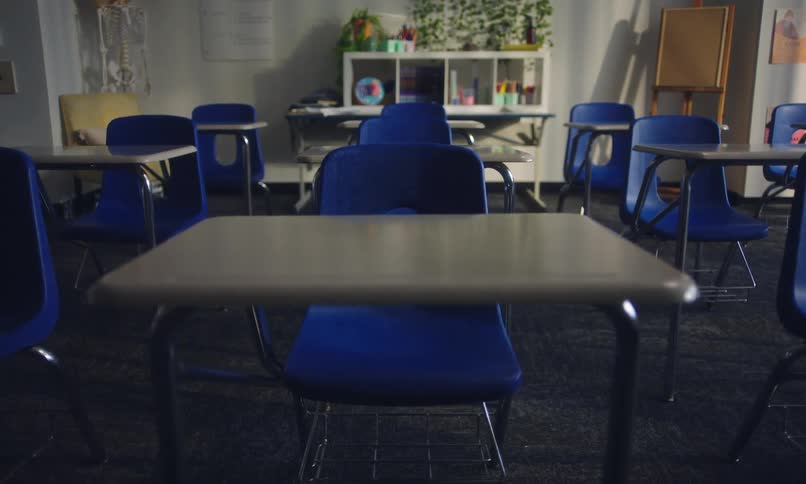 Classroom with standardized chairs and tables arranged in a row