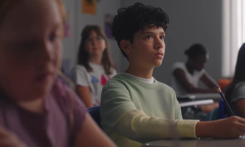 Students sitting in the classroom writing