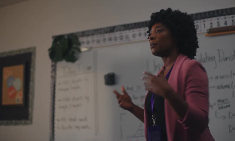 A teacher lectures to a classroom of students