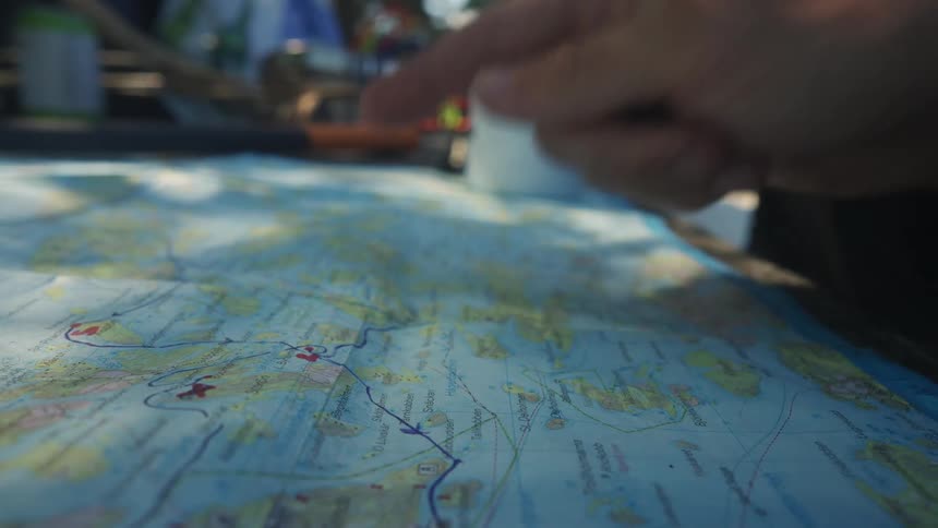 A person points at part of a map