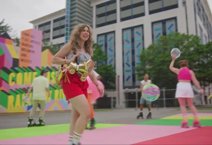 Group of people on a colorful playground rollerblading