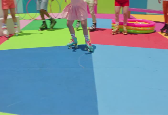 Youths enjoy themselves skating at a colorful urban skate park