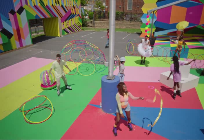 Overhead view of people on a playground rollerblading walking and dancing