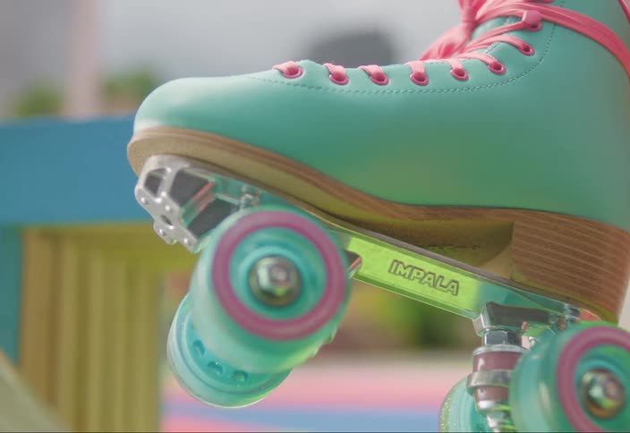 Hand spinning the small wheels of a colorful skate