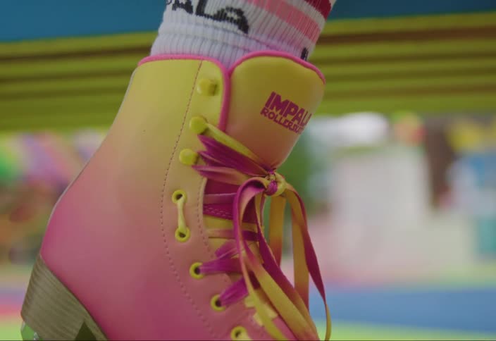 Closeup of a colorful roller skate laces with pink wheels