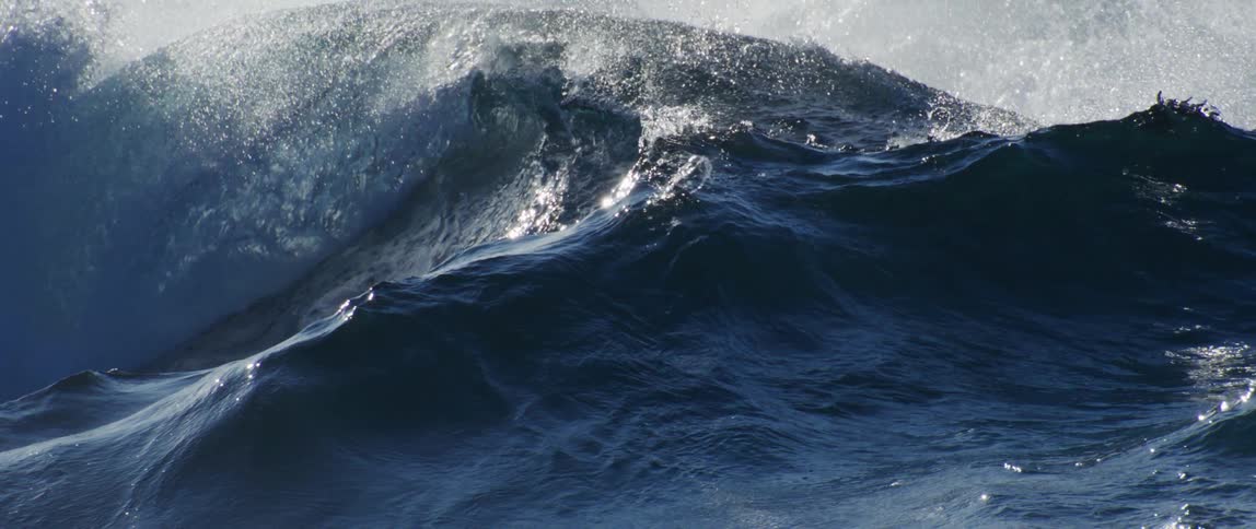 Large sea waves crash all over the ocean