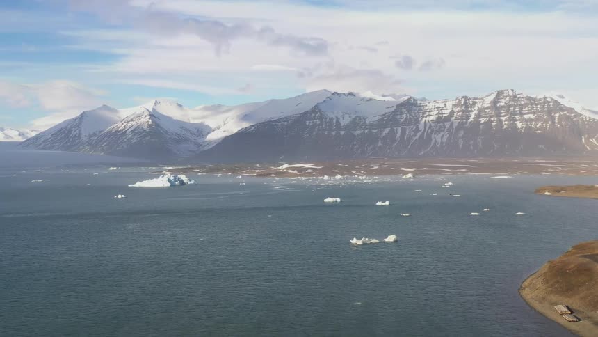 Serene landscape with a calm lake and a mountain range in the background