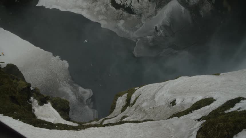 An arctic river under a mountain cliff