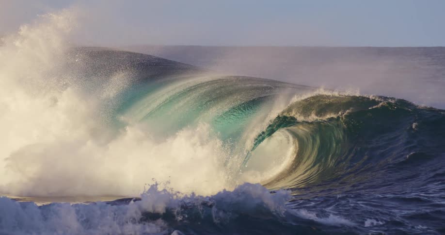 A massive wave crests in the ocean