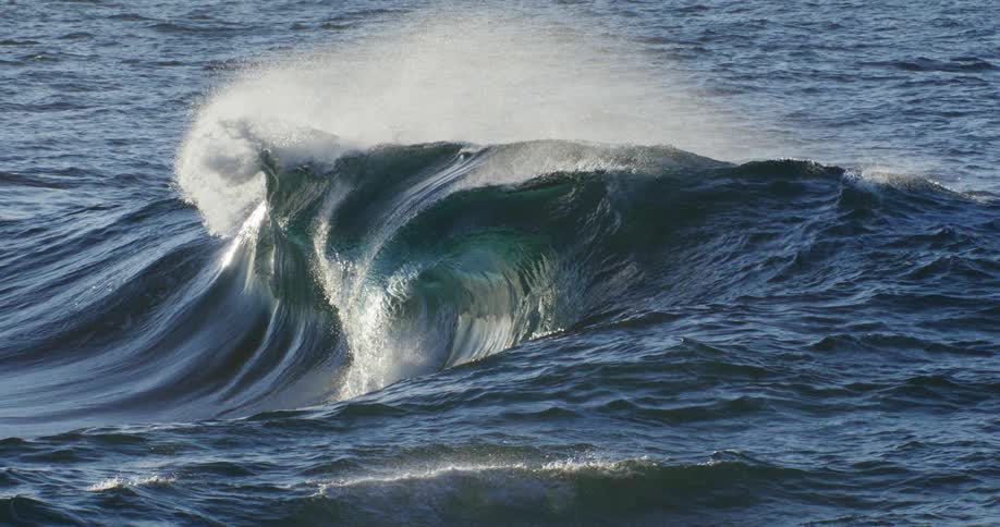 A wave in the sea is breaking on its surface