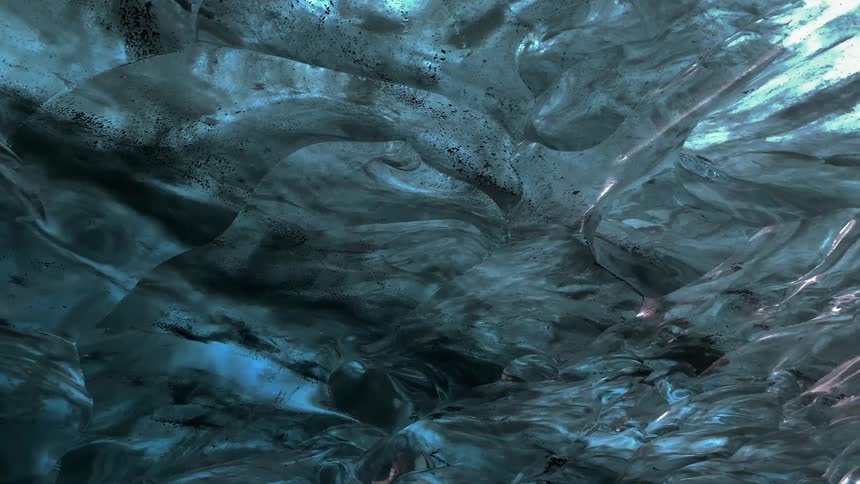 Water drips inside of a shiny cave