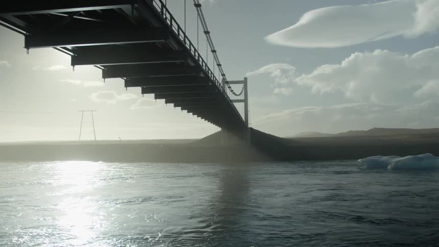 A large cable bridge is over the river