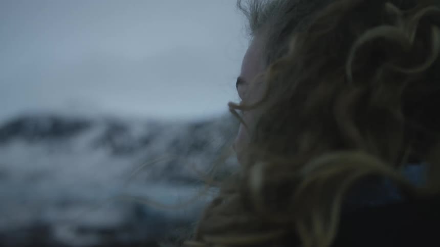A woman is looking at the mountains