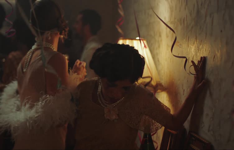 A woman leaves a party stumbling and crying