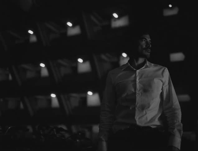 Man walking in a condominium at night