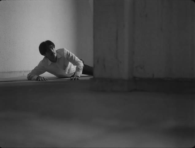 A scared man gets up from the floor