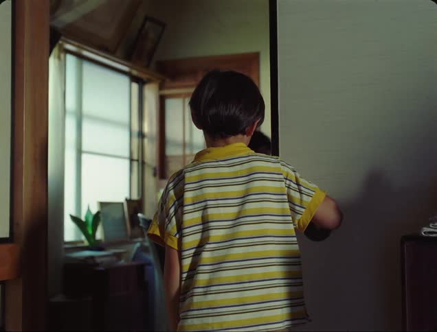 Father standing up and closing the door in front of a downcast boy
