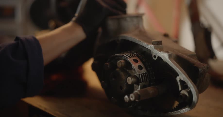A mechanic is adjusting an engine