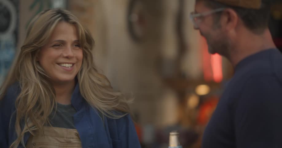 Two friends chat animatedly their faces lit up with smiles