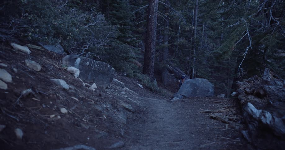 Woman running down a mountain
