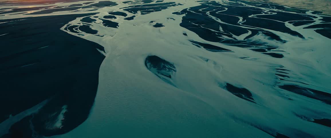 An aerial view of a river with numerous branches flowing through a landscape