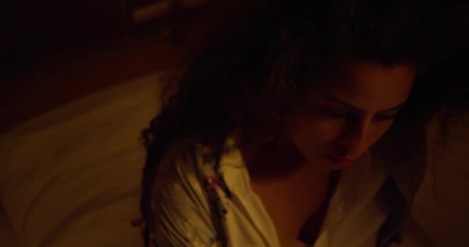 Close up of the face of a woman waking up from a nightmare in bed