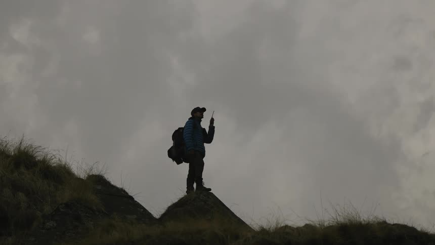 A man hikes on some rocks