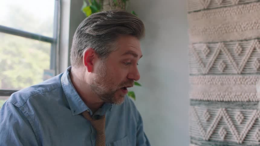 A man talks while chewing