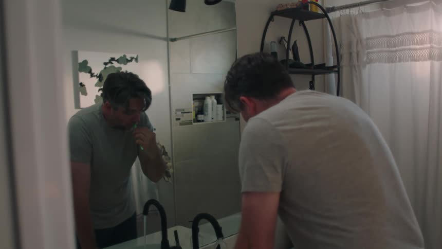A man brushes his teeth