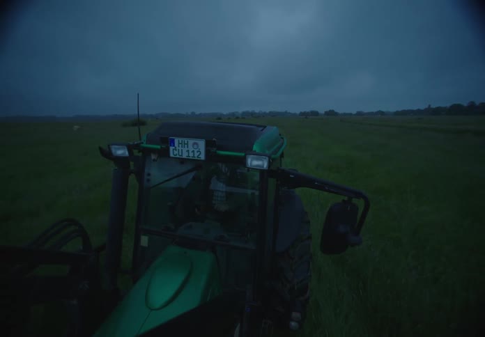 A tractor backs up in a field