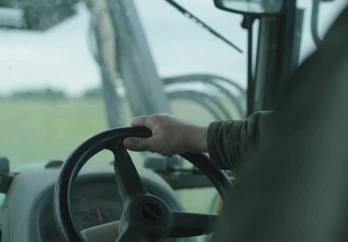 A man is driving a tractor