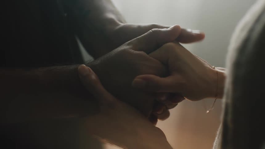 The view is of two people that are holding each others hand