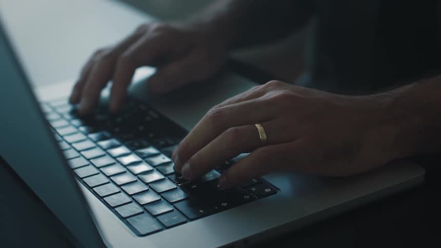 A close up of a person typing on their keyboard of their laptop