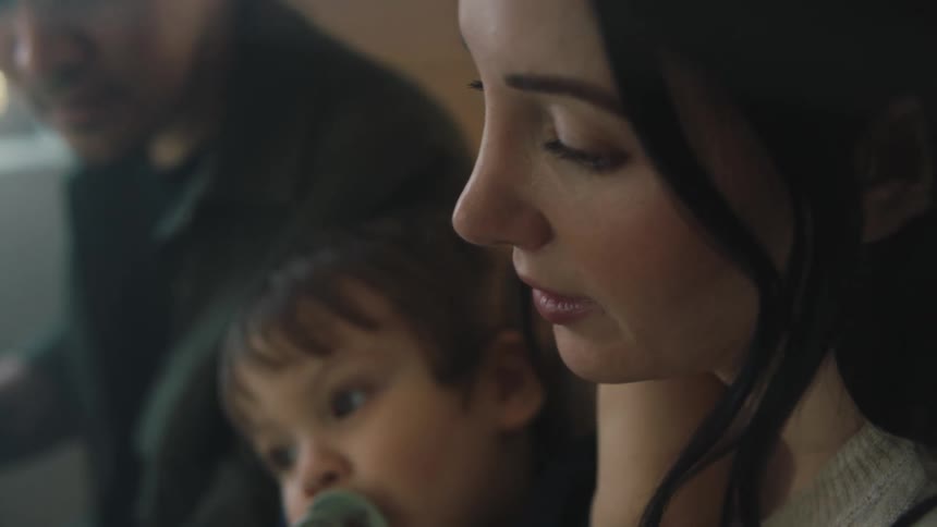 A mother is holding her baby