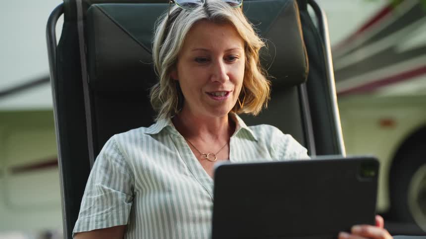 Woman sitting and talking in front of an ipad