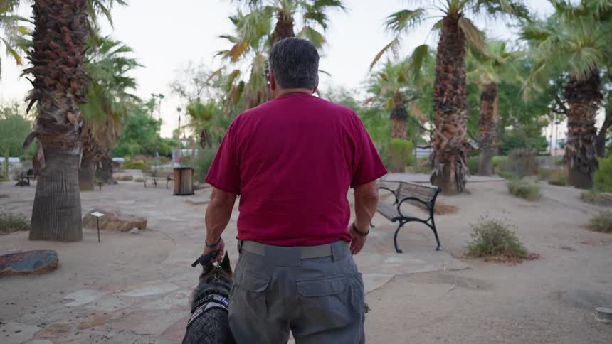 A man is walking his dog
