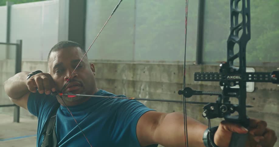Determined man practicing archery