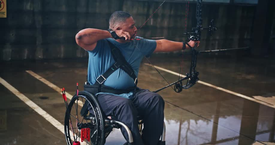 Man in a wheelchair practicing archery
