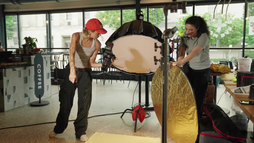 Two women are setting up for a photo shoot