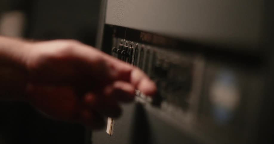 Finger lifting the levers of an electronic instrument
