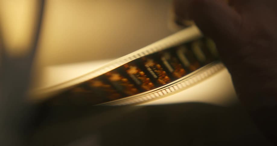 Close up of a vintage film tape being handled by a hand
