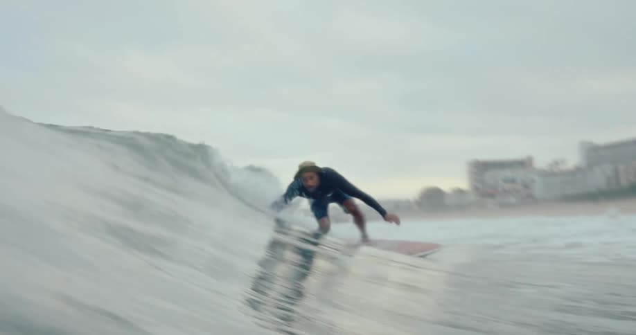 A man is surfing in the ocean